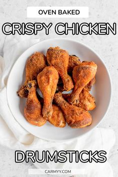 oven baked crispy chicken drumsticks on a white plate with text overlay