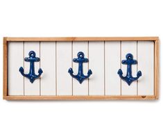 three blue anchor hooks mounted on the side of a white board with wood planks