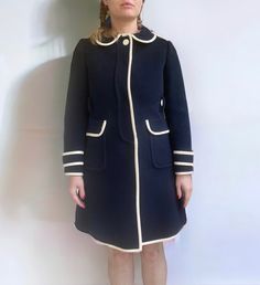 "Gorgeous and very rare 1960s navy wool peacoat by Calvin Klein. Coat is made of very soft wool with white trim. Peter pan collar, hits just below the knee (model is 5'4\"). Includes matching white leather belt. Has all original tags, some in the front pockets, others never removed from the sleeve but pinned inside the sleeve instead; does not detract from wear (you can't feel them when worn). Also has a Union Label sewn inside the side of the coat. * Excellent condition, no flaws to note other Vintage Navy Single-breasted Outerwear, Navy Vintage Single Breasted Outerwear, Fitted Navy Retro Outerwear, Navy Fitted Retro Outerwear, Fitted Vintage Peacoat For Work, Vintage Peacoat With Buttons For Workwear, Vintage Peacoat With Buttons For Work, Vintage Peacoat For Fall Workwear, Vintage Fitted Peacoat With Buttons