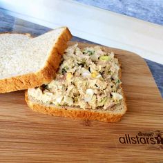 there is a sandwich on the cutting board