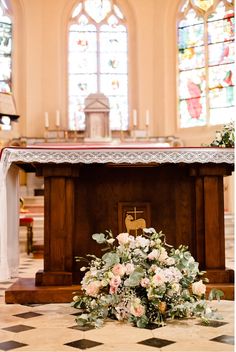 flowers are placed on the ground in front of an altar