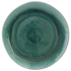 a green bowl is shown on a white background