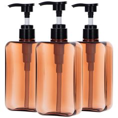 three soap dispensers are shown with brown bottles and black caps on them