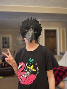 a person wearing a mask with a bird on it's face