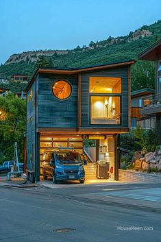 a blue truck parked in front of a house on the side of a road at night