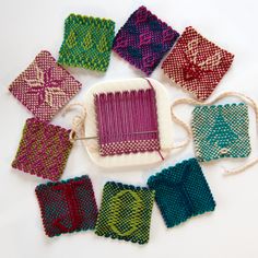 a group of knitted squares sitting on top of a table next to each other