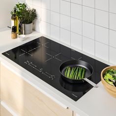 a pan with some food cooking on top of it in the middle of a stove