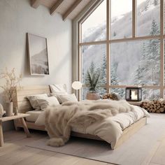 a bedroom with a large window and a bed in front of a snowy mountain view