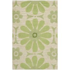 a green and white rug with flowers on it