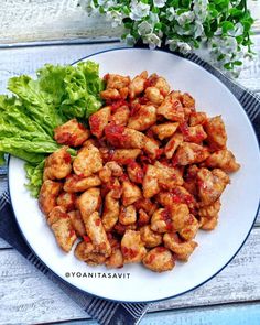 a white plate topped with chicken and lettuce