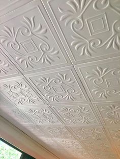 the ceiling is painted white with decorative designs