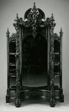 an ornately decorated mirror is shown in this black and white photo with dark lighting