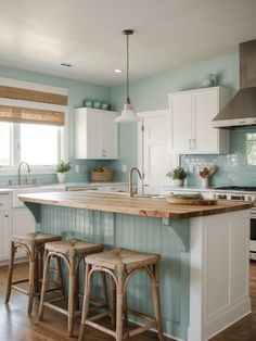 a kitchen with blue walls and white cabinets