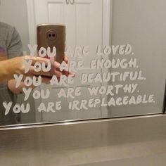 someone taking a selfie in front of a mirror with the words you are loved