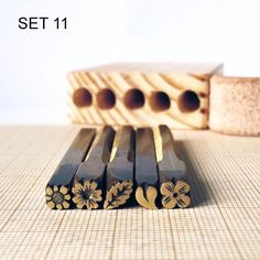 four wooden dowks sitting on top of a table next to a piece of wood