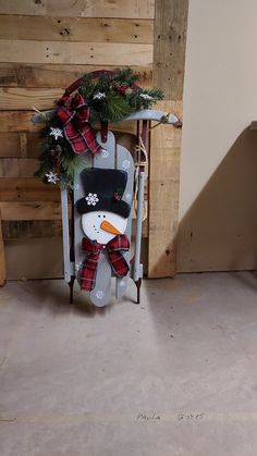 a snowman sitting on top of a sled