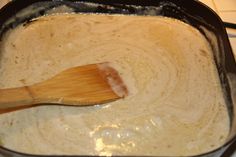 a wooden spoon stirring batter in a pan