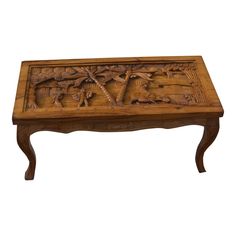 an old wooden table with carvings on it