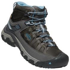 a pair of hiking shoes with blue laces on the outstep and grey upper part