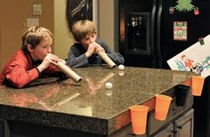 two children are playing baseball on the kitchen counter