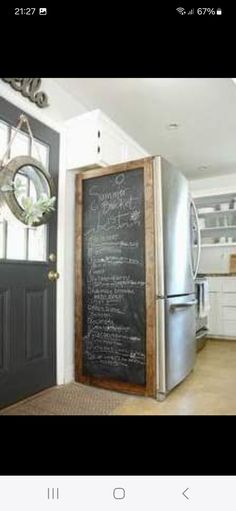 a kitchen with a chalkboard on the wall