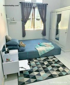 a bed room with a neatly made bed next to a dresser and window sill