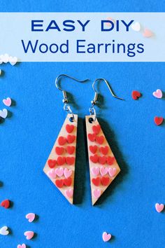 two wooden earrings with hearts on them and the words easy diy wood earrings