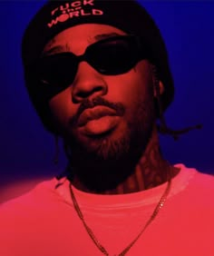 a man wearing sunglasses and a hat with the words swipe up 4 exhaust new music