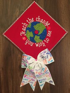 a red graduation cap with the words, save the change you wish to see on it