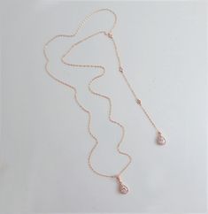 "CZ WEDDING BACKDROP NECKLACE This very elegant Lariat Back Necklace is perfect for that special occasion. This has a delicate a teardrop pendant that is surrounded by CZs in the front. Gorgeous! IT'S IN THE DETAILS ✦ Gold Filled, Rose Gold Filled or Sterling Silver Chain ✦ Shown at 26\" with an 6\" drop (No Clasp) ✦ Rose Gold or Silver Teardrop Shape CZ ✦ Shown with a 6\" drop ✦ Set of 2 includes: Necklace and Earrings ✦ Please note: No returns on wedding jewelry 🎁 To View Bridesmaids Gift, Cl Wedding Necklaces With Adjustable Cubic Zirconia Chain, Rose Gold Necklace With Adjustable Chain For Wedding, Rose Gold Necklaces With Adjustable Chain For Wedding, Rose Gold Lariat Jewelry For Wedding, Wedding Pendant Drop Necklace With Adjustable Chain, Rose Gold Lariat Necklace For Wedding With Adjustable Chain, Rose Gold Clavicle Chain Necklace For Wedding, Gold Lariat Pendant Necklace For Wedding, Gold Pendant Lariat Necklace For Wedding