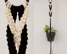 two crocheted necklaces hanging on hooks next to a potted plant