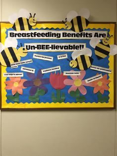 a bulletin board with paper flowers and bees on it that says, breastfeeding benefits are un - bee - belevable