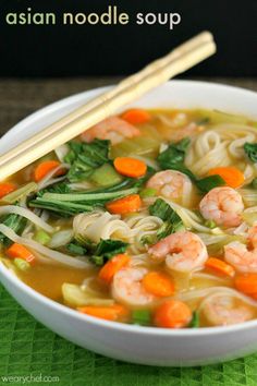 a bowl of shrimp noodle soup with chopsticks