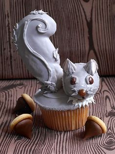 a cupcake shaped like a squirrel sitting on top of it's back legs