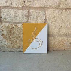 a yellow and white sign with a coffee cup on it