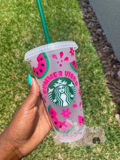 a hand holding up a starbucks cup with watermelon designs on it and a green straw