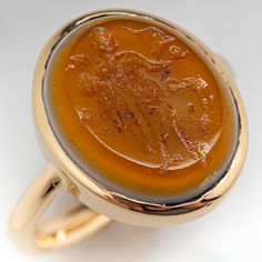 This intriguing antique mens ring is crafted of 18k yellow gold and holds a bezel set intaglio sardonyx cabochon. It has a smooth and simple design and is very confortable on the finger. The ring is currently size 8.5. Antique Mens Rings, Ancient Stone, Brand Presentation, Cabochon Ring, Mens Ring, October Birth Stone, Men's Jewelry, Oval Cabochon, Moscow Mule Mugs