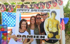 two women and one man are holding up a sign that says, happy birthday damien