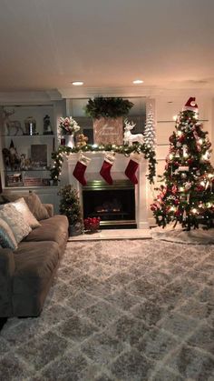 the living room is decorated for christmas with stockings and garlands on the mantel