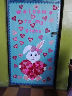 a door decorated with hearts and an image of a bunny holding a heart shaped pillow