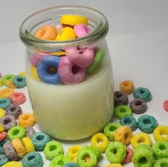 a jar filled with cereal and doughnuts on top of a table