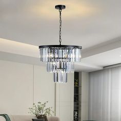 a chandelier hanging from the ceiling in a living room