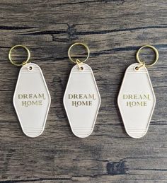 three keychains with the words dream, dream home and dream home written on them