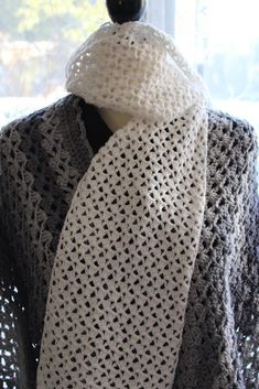 a white crocheted scarf on top of a mannequin