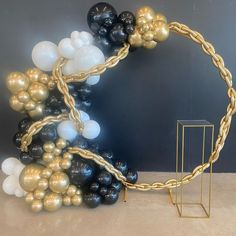 a bunch of balloons that are in the shape of a circle with chains and balls