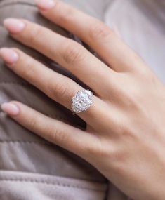 a woman's hand with a diamond ring on it