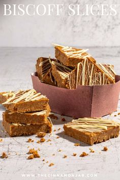 Biscoff slices in a pink carton box with a few slices in the foreground.