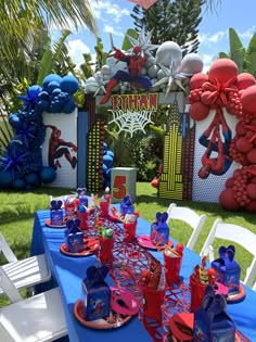 a table set up for a spiderman birthday party