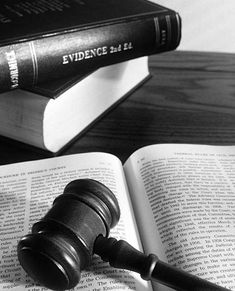 a judge's gavel sitting on top of an open book