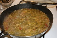 a pan filled with food sitting on top of a stove